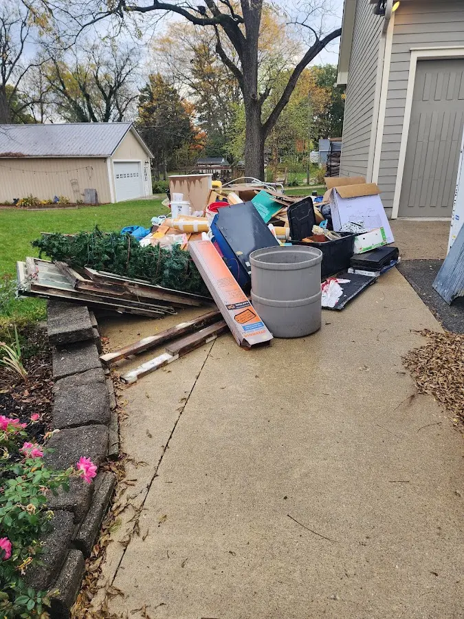 Dumpster being loaded with debris for Residential Dumpster Rental in Plainview